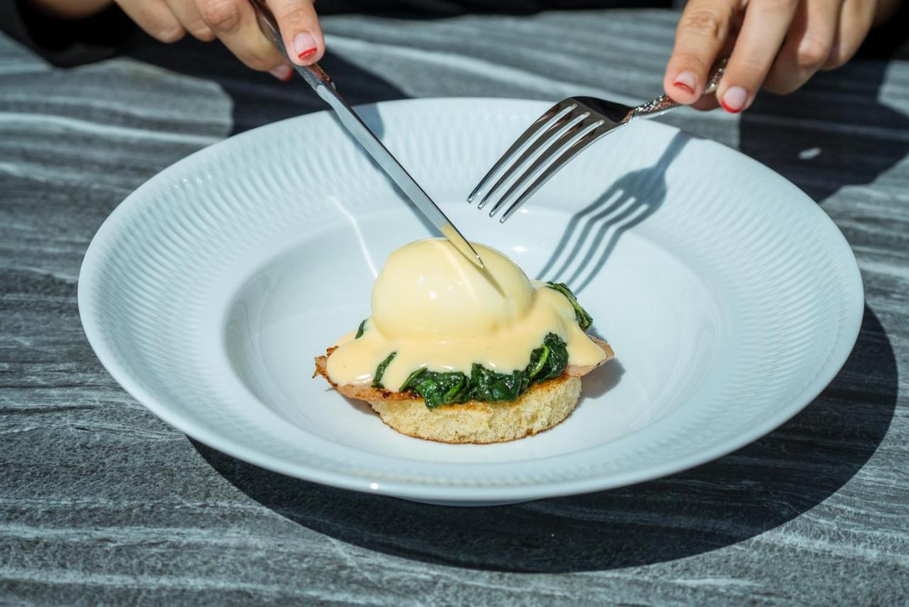 El Llorenc Parc De La Mar - Adults Only Палма де Майорка Екстериор снимка A poached egg being cut with a knife and fork
